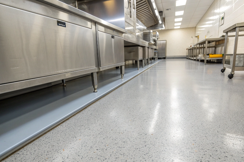 Professional chefs working safely on slip-resistant epoxy flooring in busy Toowoomba commercial kitchen